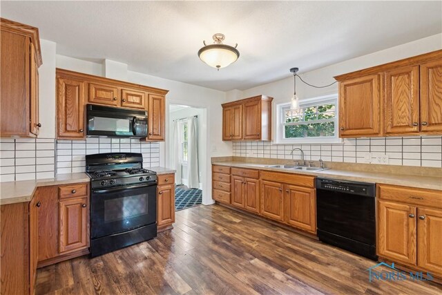 2904 Goddard Rd, Toledo, OH 43606 - kitchen with black appliances, a sink, decorative backsplash, and light countertops