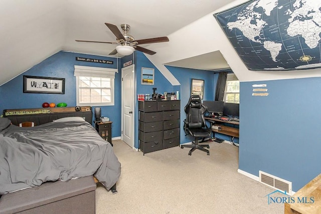 2838 Secor Rd, Toledo, OH 43606 - carpeted bedroom with an office area, lofted ceiling, multiple windows, a ceiling fan, and baseboards