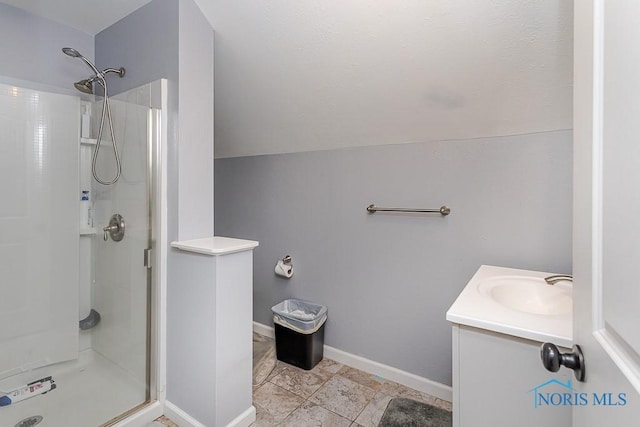 2838 Secor Rd, Toledo, OH 43606 - bathroom featuring a shower stall, vanity, tile patterned flooring, lofted ceiling, and baseboards