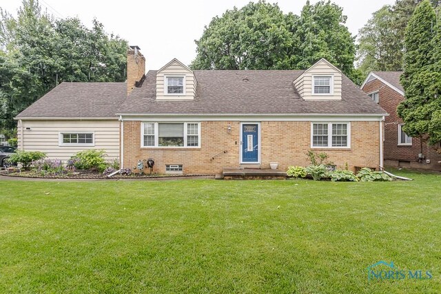 2838 Secor Rd, Toledo, OH 43606 - new england style home featuring brick siding, a front yard, a chimney, and a shingled roof