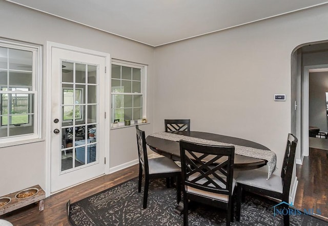 2838 Secor Rd, Toledo, OH 43606 - dining area with wood finished floors, arched walkways, and baseboards
