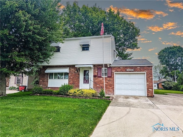 1006 Leonard Ct, Fostoria, OH 44830 - colonial-style house featuring a garage, concrete driveway, brick siding, and a yard