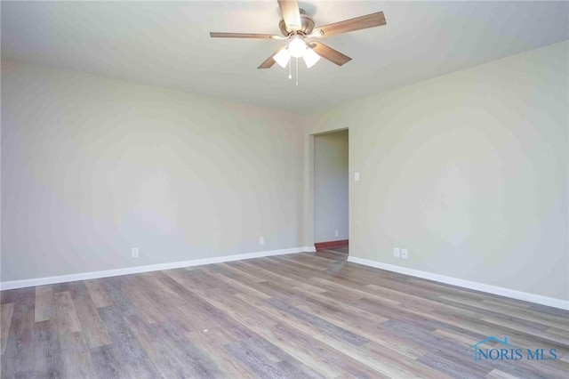 1816 Cherry Ln, Findlay, OH 45840 - spare room featuring wood finished floors, a ceiling fan, and baseboards