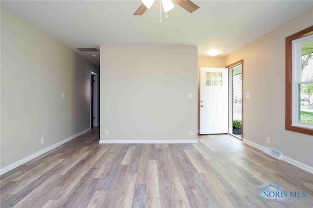 1816 Cherry Ln, Findlay, OH 45840 - unfurnished living room featuring a ceiling fan, light wood finished floors, and baseboards