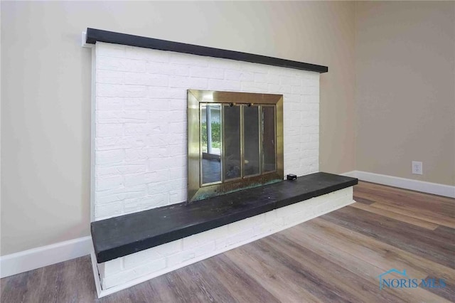 1816 Cherry Ln, Findlay, OH 45840 - detailed view of wood finished floors, baseboards, and a brick fireplace
