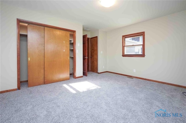 1816 Cherry Ln, Findlay, OH 45840 - unfurnished bedroom with a closet, carpet floors, and baseboards