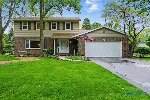 2009 Saratoga Dr, Findlay, OH 45840 - view of front of property featuring driveway, a front lawn, a garage, and brick siding
