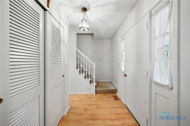 2009 Saratoga Dr, Findlay, OH 45840 - entrance foyer with light wood-style floors, stairs, and baseboards