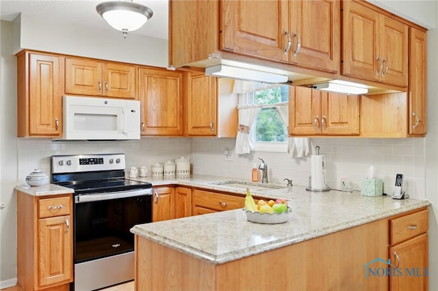 2009 Saratoga Dr, Findlay, OH 45840 - kitchen featuring white microwave, stainless steel range with electric stovetop, a sink, and backsplash