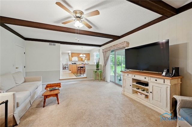 2009 Saratoga Dr, Findlay, OH 45840 - living area featuring beam ceiling, a ceiling fan, light colored carpet, and a chandelier