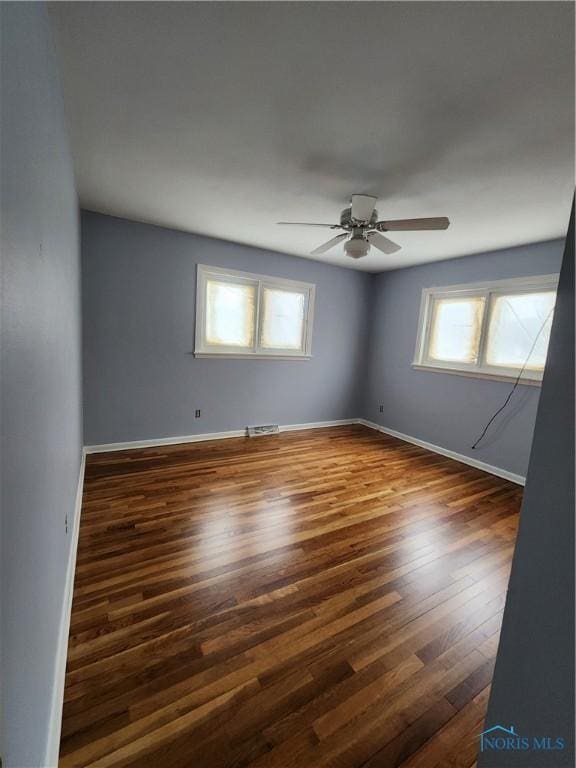 514 E Indiana, Maumee, OH 43537 - unfurnished room with dark wood-style floors, ceiling fan, and baseboards