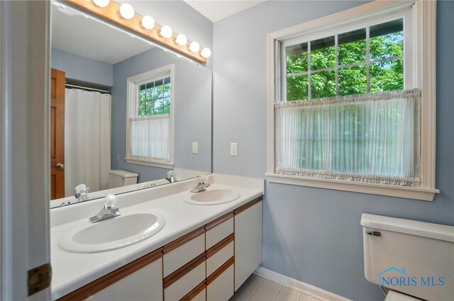 1301 Forest Park, Findlay, OH 45840 - bathroom featuring toilet, double vanity, baseboards, and tile patterned flooring