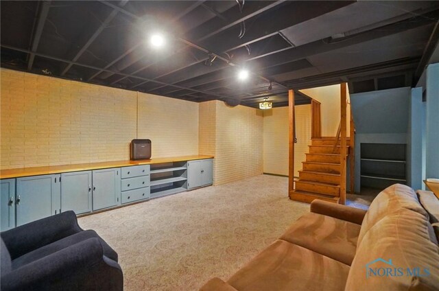 1301 Forest Park, Findlay, OH 45840 - living area with carpet flooring, brick wall, and stairs