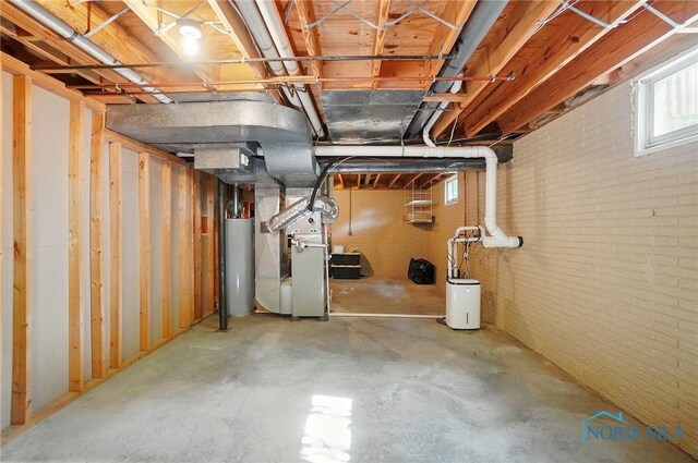 1301 Forest Park, Findlay, OH 45840 - below grade area featuring water heater, heating unit, and brick wall