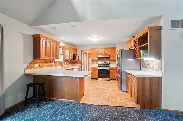 1301 Forest Park, Findlay, OH 45840 - kitchen featuring appliances with stainless steel finishes, a peninsula, a sink, backsplash, and under cabinet range hood