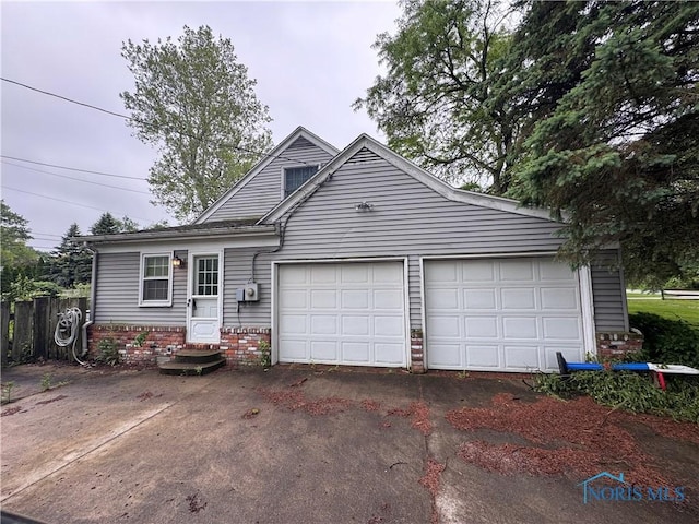 3634 Corey Rd, Toledo, OH 43615 - view of front of property featuring brick siding, asphalt driveway, and an attached garage