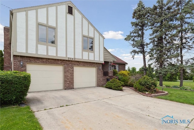 2142 Tracy Rd, Northwood, OH 43619 - view of front of property with brick siding, concrete driveway, an attached garage, stucco siding, and a front yard