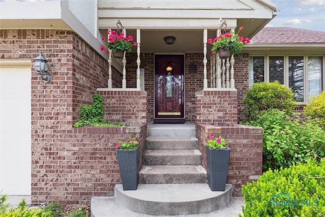 2142 Tracy Rd, Northwood, OH 43619 - property entrance with brick siding and a garage