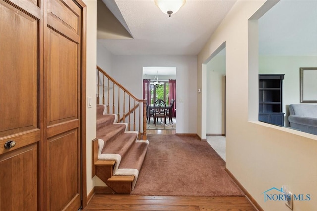 2142 Tracy Rd, Northwood, OH 43619 - entryway with stairway, a chandelier, baseboards, and wood finished floors