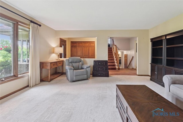 2142 Tracy Rd, Northwood, OH 43619 - living area featuring stairway, light colored carpet, and baseboards