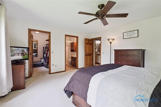 2142 Tracy Rd, Northwood, OH 43619 - bedroom with a walk in closet, light colored carpet, baseboards, ensuite bathroom, and a closet