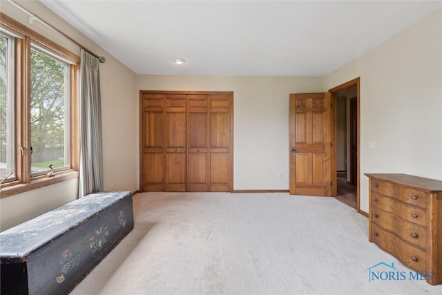 2142 Tracy Rd, Northwood, OH 43619 - unfurnished bedroom featuring a closet, light carpet, and baseboards