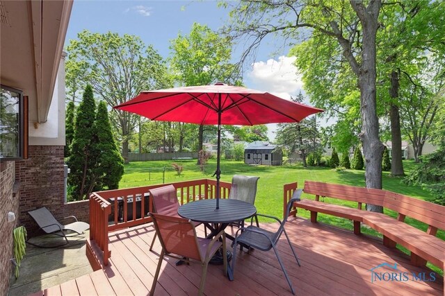 2142 Tracy Rd, Northwood, OH 43619 - deck featuring outdoor dining space, a yard, and an outbuilding