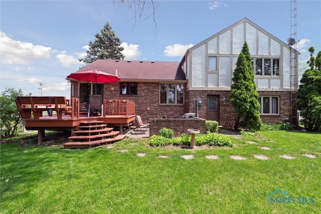 2142 Tracy Rd, Northwood, OH 43619 - rear view of property featuring a deck, brick siding, and a lawn