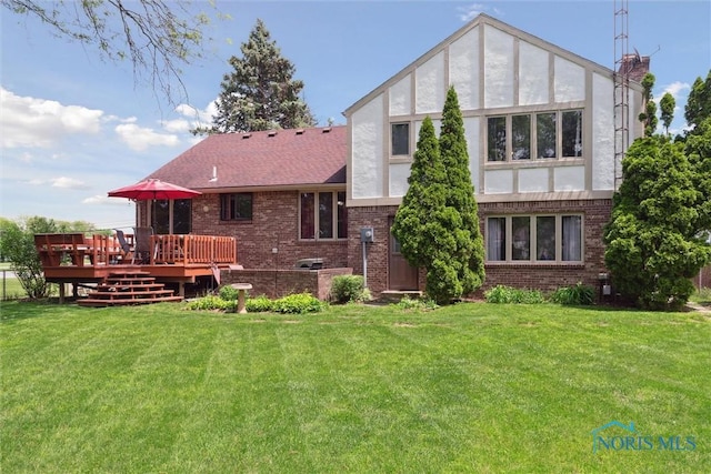 2142 Tracy Rd, Northwood, OH 43619 - rear view of house featuring brick siding, a wooden deck, a lawn, and stucco siding