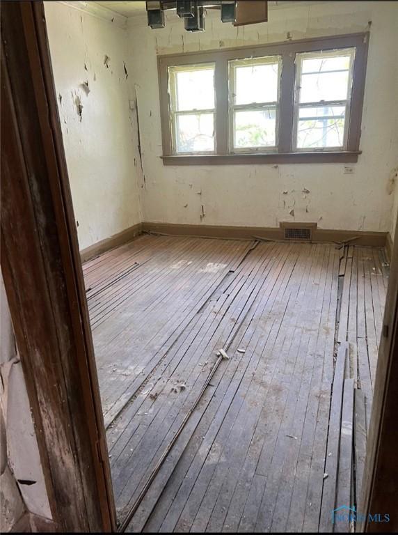 636 Nesslewood Ave, Toledo, OH 43610 - spare room with hardwood / wood-style floors, healthy amount of natural light, and baseboards