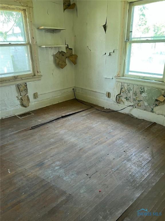 636 Nesslewood Ave, Toledo, OH 43610 - empty room with wood-type flooring and healthy amount of natural light