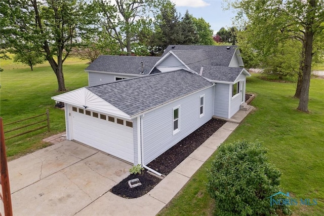 10540 Veler Rd, Curtice, OH 43412 - view of property exterior featuring a shingled roof, a garage, concrete driveway, and view of scattered trees