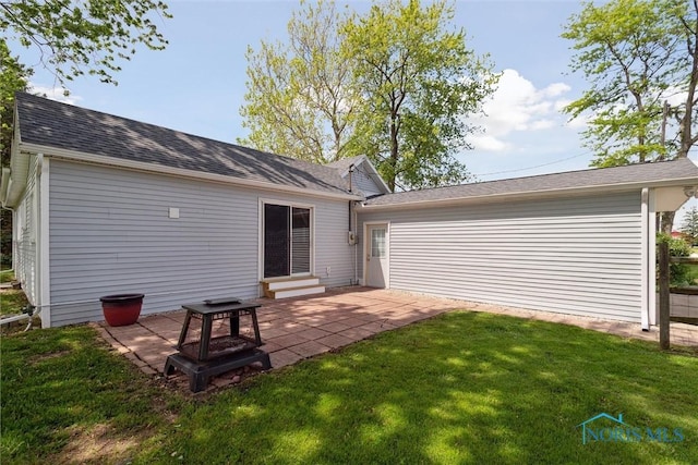 10540 Veler Rd, Curtice, OH 43412 - rear view of house with a lawn, a patio area, roof with shingles, and entry steps