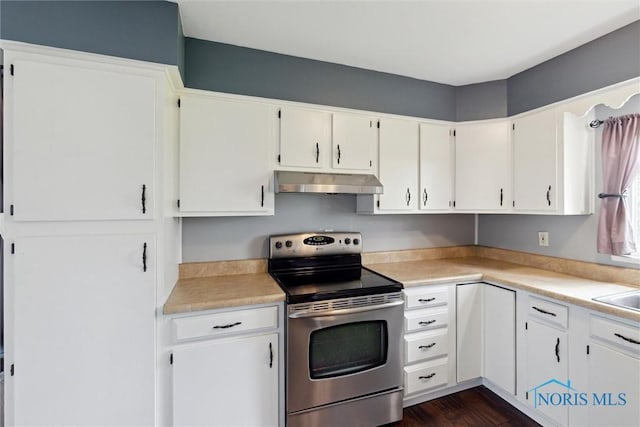 10540 Veler Rd, Curtice, OH 43412 - kitchen featuring stainless steel electric stove, under cabinet range hood, light countertops, white cabinets, and dark wood finished floors