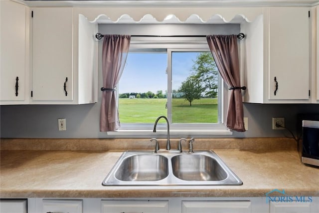 10540 Veler Rd, Curtice, OH 43412 - kitchen with a sink and white cabinetry