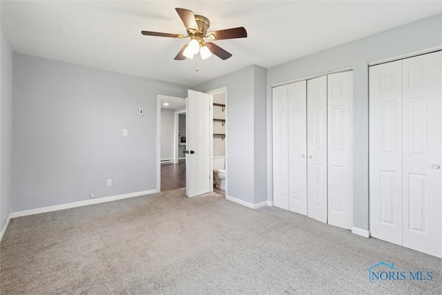 10540 Veler Rd, Curtice, OH 43412 - unfurnished bedroom with carpet floors, two closets, baseboards, a ceiling fan, and baseboard heating