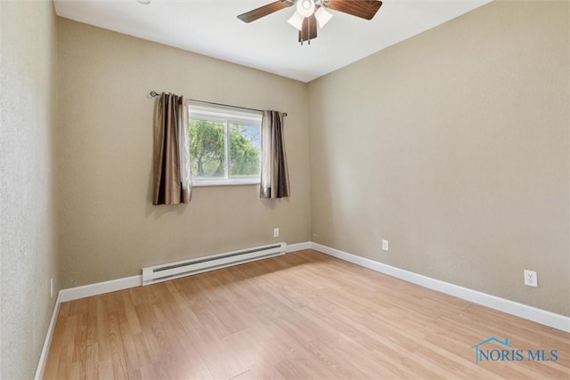 10540 Veler Rd, Curtice, OH 43412 - empty room featuring a baseboard radiator, ceiling fan, wood finished floors, and baseboards