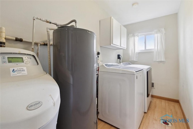 10540 Veler Rd, Curtice, OH 43412 - washroom with independent washer and dryer, electric water heater, cabinet space, and light wood-style floors
