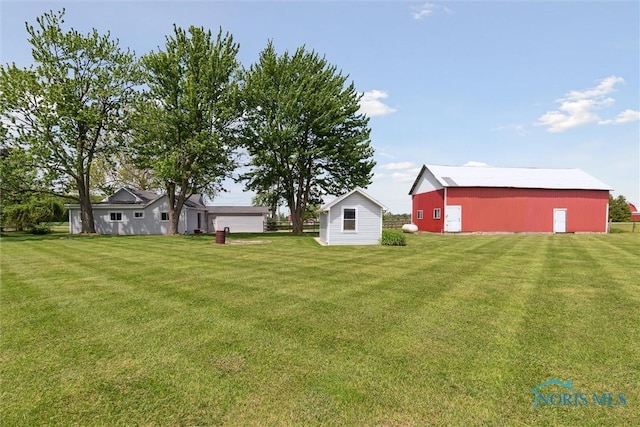 10540 Veler Rd, Curtice, OH 43412 - view of grassy yard featuring an outbuilding, a detached garage, and a pole building