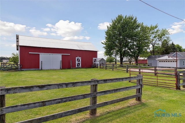 10540 Veler Rd, Curtice, OH 43412 - view of yard featuring a detached garage, an outdoor structure, and a barn