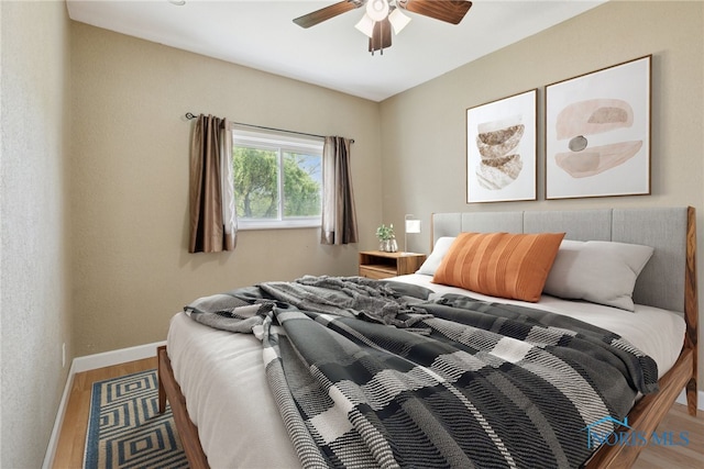10540 Veler Rd, Curtice, OH 43412 - bedroom featuring wood finished floors, baseboards, and a ceiling fan