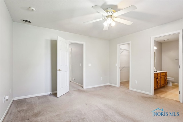 209 E Sawmill Rd, Findlay, OH 45840 - unfurnished bedroom featuring light colored carpet, a spacious closet, baseboards, connected bathroom, and a closet
