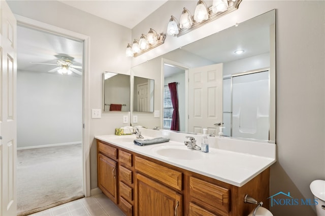 209 E Sawmill Rd, Findlay, OH 45840 - bathroom featuring ceiling fan, double vanity, an enclosed shower, toilet, and baseboards