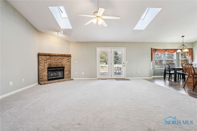 209 E Sawmill Rd, Findlay, OH 45840 - unfurnished living room featuring a skylight, high vaulted ceiling, baseboards, and a fireplace