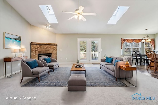 209 E Sawmill Rd, Findlay, OH 45840 - living room with a skylight, a ceiling fan, high vaulted ceiling, a fireplace, and baseboards