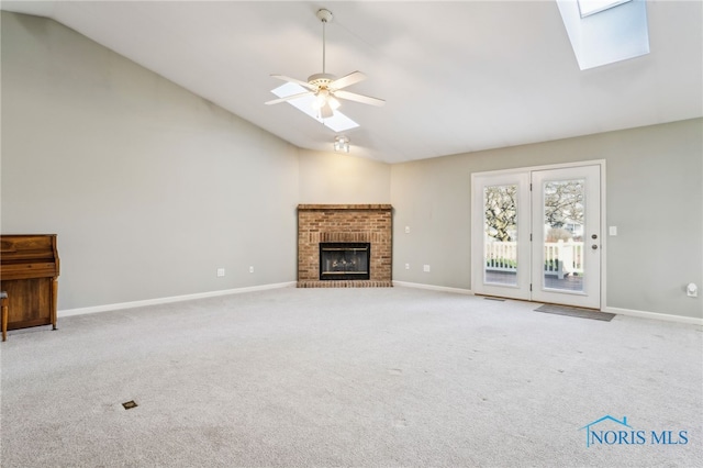 209 E Sawmill Rd, Findlay, OH 45840 - unfurnished living room with carpet, high vaulted ceiling, a fireplace, a skylight, and baseboards