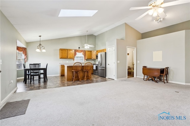 209 E Sawmill Rd, Findlay, OH 45840 - kitchen with stainless steel fridge with ice dispenser, dark colored carpet, a center island, open floor plan, and baseboards