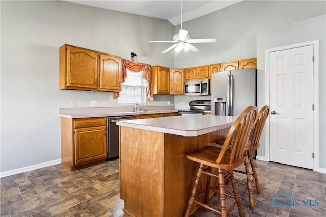 209 E Sawmill Rd, Findlay, OH 45840 - kitchen featuring stainless steel appliances, a sink, a ceiling fan, stone finish floors, and baseboards
