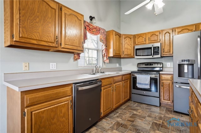 209 E Sawmill Rd, Findlay, OH 45840 - kitchen with appliances with stainless steel finishes, a sink, light countertops, stone finish flooring, and ceiling fan