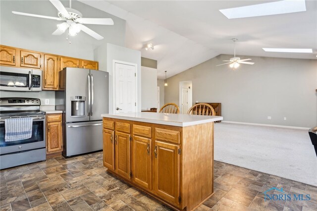 209 E Sawmill Rd, Findlay, OH 45840 - kitchen featuring stainless steel appliances, a skylight, ceiling fan, lofted ceiling, and light countertops